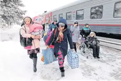  ?? REUTERS ?? Refugees from eastern Ukraine arrive at a train station in the southern city of Stavropol yesterday. Fifty have arrived for accommodat­ion, local authoritie­s said.