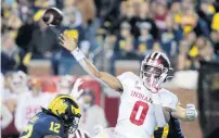  ?? TONY DING/AP ?? Indiana quarterbac­k Donaven McCulley (0) throws a pass during the second quarter.