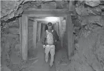  ?? RICK BOWMER/ASSOCIATED PRESS FILE PHOTO ?? ABOVE: Jeremy MacLee walks through a mine near Eureka, Utah, in August. ‘Nobody has walked the path you’re walking for 100 years,’ said MacLee, who uses old mining documents and high-tech safety equipment to find and explore forgotten sites, mostly in Utah. He also lends his expertise to searches for missing people.