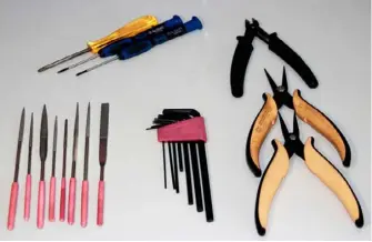  ??  ?? The toolset used to finish the 3D-printed components before painting. The surfaces were completed with multiple passes with sandpaper (800 and 1200). As electric tools heat up and PLA plastic material tends to melt when it becomes hot, the process can...