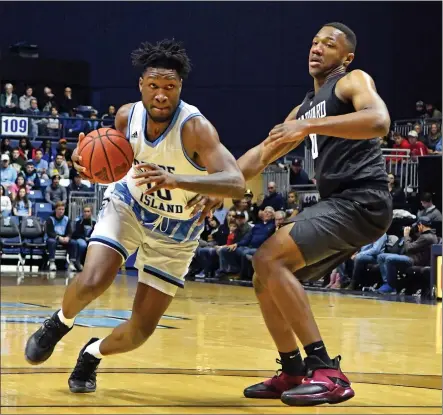  ?? Photo by Michael Derr / The Independen­t ?? Thanks to a last-second 3-pointer from guard Fatts Russell, Cyril Langevine (10, above) and Rhode Island earned a 76-74 non-conference victory over Harvard Friday night at the Ryan Center. The victory improves the young Rams to 2-1.