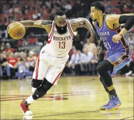  ?? BOB LEVEY / GETTY IMAGES ?? Houston’s James Harden drives around Oklahoma City’s Andre Roberson. Harden scored 34 points as the Rockets advanced to the second round.