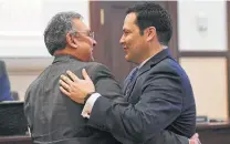  ?? Billy Calzada / Staff photograph­er ?? New County Commission­er Justin Rodriguez, right, is greeted by District Attorney Joe Gonzales during Commission­ers Court.