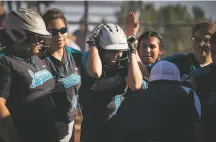  ??  ?? Capital High School’s Alex Hernandez is congratula­ted after hitting a home run against Albuquerqu­e Academy during Wednesday’s game. Academy won 8-4 in extra innings.