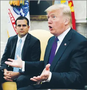  ?? AP/EVAN VUCCI ?? During a visit Thursday in the Oval Office with Puerto Rico Gov. Ricardo Rossello, President Donald Trump said rebuilding the island’s power infrastruc­ture will take “a while.” He said the island now has “massive numbers” of generators that he sent.