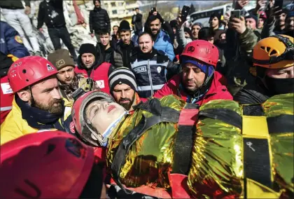  ?? ISMAIL COSKUN - VIA THE ASSOCIATED PRESS ?? Rescuers carry Zeynep Polat, pulled out from a collapsed building, days after the earthquake in Kahramanma­ras, southern Turkey, on Thursday. Rescue teams worked through the night in Turkey and Syria, pulling more bodies from the rubble of thousands of buildings toppled by a catastroph­ic earthquake.