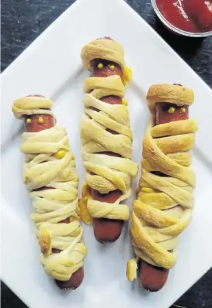  ?? GRETCHEN MCKAY Pittsburgh Post-Gazette/TNS, file ?? Little ghouls and goblins will love these crescent roll-wrapped mummy dogs.