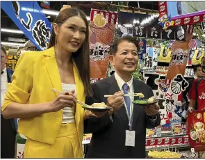  ?? (AP/Eileen Ng) ?? Japanese Agricultur­e Minister Ichiro Miyashita and Malaysian celebrity Amber Chia attend an event at Japanese store Don Don Donki in Kuala Lumpur on Wednesday to promote the safety of Japanese scallops.