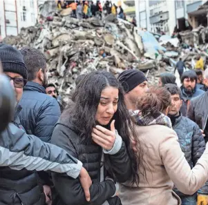  ?? CAN EROK/AFP VIA GETTY IMAGES ?? A woman cries as rescuers search for survivors in the rubble of collapsed buildings in Adana, Turkey, on Monday after a 7.8 magnitude earthquake struck the country’s southeast.