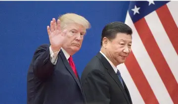  ??  ?? This file picture taken on November 9, 2017 shows US President Donald Trump (left) and China’s President Xi Jinping leaving a business leaders event at the Great Hall of the People in Beijing. The United States and China appear close to a deal that would roll back US tariffs on at least US$200 billion worth of Chinese goods, as Beijing makes pledges on structural economic changes and eliminates retaliator­y tariffs on US goods, a source briefed on negotiatio­ns said. — AFP photo