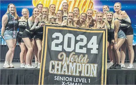  ?? ?? The East Coast Tigers Senior team show off their gold medals after winning the Allstar World Championsh­ips in Orlando, Florida.