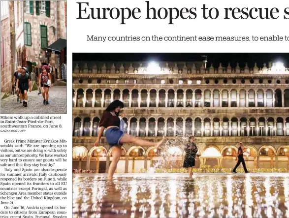  ?? GAIZKA IROZ / AFP FABRIZIO BENSCH / REUTERS ?? Hikers walk up a cobbled street in Saint-Jean-Pied-de-Port, southweste­rn France, on June 8. A tourist captures the scene in flooded St Mark’s Square in Venice, Italy, on June 18.