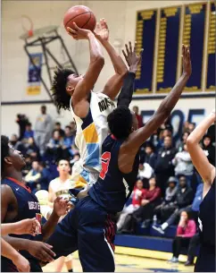  ?? RECORDER PHOTO BY CHIEKO HARA ?? Monache High School's Jlen Sims makes a shot as he is getting fouled Wednesday at the end of the fourth quarter against Tulare Western High School at Monache. Sims made the free throw to cut Tulare Western's lead to 63-62.