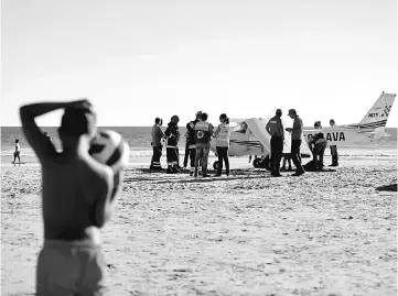  ??  ?? The plane which landed on the Sao Joao Beach in Costa da Caparica, Portugal. — Reuters photo