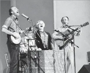  ?? Richard Drew
Associated Press ?? ‘SHE WAS A WOMAN SINGING SO STRONGLY IN A MAN’S WORLD’ In November 1980, the Weavers perform in a 25th anniversar­y reunion concert at Carnegie Hall. Ronnie Gilbert, third from left, is joined by Pete Seeger, Lee Hays and Fred Hellerman.