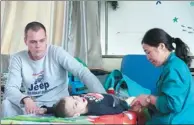  ?? PROVIDED TO CHINA DAILY ?? A foreign child with a brain disease receives scalp acupunctur­e treatment in Yuncheng, Shanxi province.