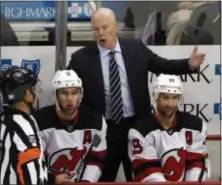  ?? GENE J. PUSKAR — THE ASSOCIATED PRESS ?? Devils head coach John Hynes talks with referee Marc Joannette (25) during a November game against the Penguins.