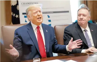  ?? Reuters-Yonhap ?? U.S. President Donald Trump speaks next to U.S. Secretary of State Mike Pompeo during a cabinet meeting at the White House in Washington, Monday.