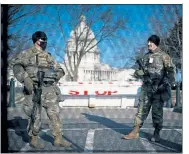  ?? ALYSSA SCHUKAR / NYTNS ?? Armed Michigan National Guard soldiers are stationed outside the Capitol building in Washington on Thursday.