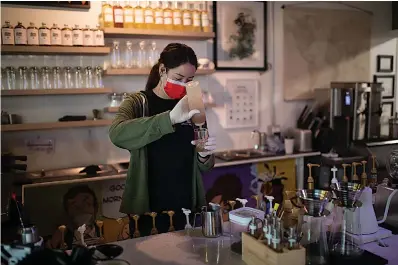  ?? Staff photo by Kelsi Brinkmeyer ?? ■ Taylor Bowman, barista at Urban Tea Town, measures out a syrup to mix in a customer’s drink on Thursday.