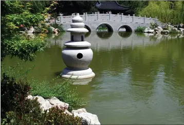  ?? PHOTOS COURTESY OF THE TRINOSKEYS ?? A lake statue is pictured in a Chinese garden.