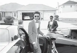  ?? ?? Jeremiah, left, and Josiah Posley get in their family’s vehicles outside their home in Sauk Village on April 29 before leaving for prom.