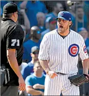  ?? AP/CHARLES REX ARBOGAST ?? Chicago Cubs starting pitcher John Lackey yells at home plate umpire Jordan Baker during the fifth inning of Friday’s game with the St. Louis Cardinals at Wrigley Field. Lackey was ejected by Baker for arguing a called ball. Moments later, Cubs catcher...