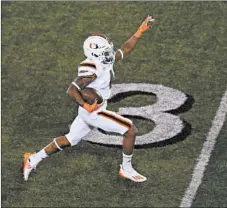  ?? ANDY LYONS/GETTY ?? Jaylan Knighton heads to the end zone for a 75-yard TD in Miami’s win.