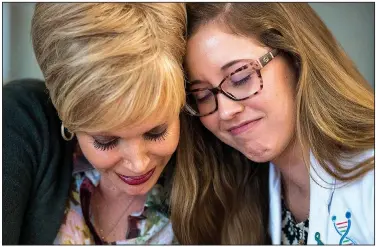  ?? NWA Democrat-Gazette/CHARLIE KAIJO ?? Marilyn Marshall-Miller (left) of Joplin, Mo., has a tearful moment Friday with genetic counselor Courtney Cook as she reflects on her experience with genetic counseling at the Highland Oncology Clinic in Rogers.