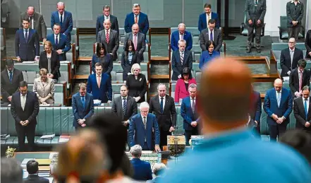  ?? — Reuters ?? Silent solidarity: Australian parliament­arians standing for a minute of silence to honour the people killed and wounded in the Manchester explosion during Question Time in Parliament in Canberra.