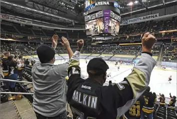  ?? Peter Diana/Post-Gazette photos ?? Fans cheer on the Penguins as they come onto the ice to play the Philadelph­ia Flyers on Tuesday at PPG Paints Arena.
