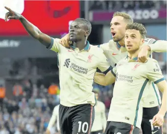  ?? AP ?? Liverpool’s Sadio Mane (left) celebrates with his teammates after scoring against Aston Villa during the English Premier League at Villa Park in Birmingham, England yesterday. Also in photograph are Jordan Henderson (centre) and Diogo Jota.