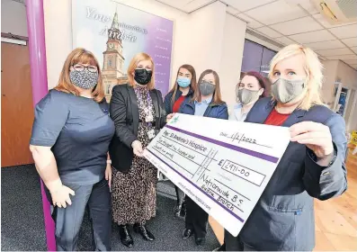  ?? ?? Very appreciati­ve Lorna Mccafferty of the hospice accepts the latest donation from Nationwide Airdrie’s Marion Denholm, Kayleigh Adair, Janet Tinley, Michelle Boyd and Carol Fleming