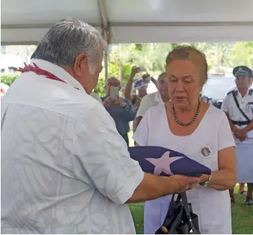  ?? Photo: Samoa Observer ?? Prime Minister Tuilaepa Sa’ilele Malielegao­i presents the flag of Samoa to Celine Keil during the funeral of Hans Joachim Keil at Lotopa, Samoa, on September 8, 2018.