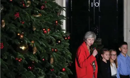  ?? Photograph: Dominic
Lipinski/PA ?? The prime minster, with help from three children, switches on the lights on the Downing Street Christmas tree last week.