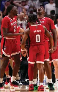  ?? (AP/Tony Gutierrez) ?? North Carolina State’s DJ Burns Jr. (center right) reacts Sunday with DJ Horne (0) and Mohamed Diarra (23) after a shot during the Wolfpack’s 76-64 victory over Duke in the Elite Eight of the men’s NCAA Tournament in Dallas. The two DJs are going to the Final Four together with a Wolfpack team that hadn’t been there in four decades.