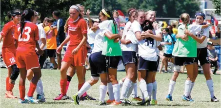  ?? PHOTO BY STEVE GOOCH, THE OKLAHOMAN ?? Members of Tophat 17 Gold soccer team, right, celebrate their win over OFC 99 at the Edmond Soccer Club Complex on Thursday. With the win, Tophat became the 2013 Under-14 U.S. Youth Soccer Region III champion.