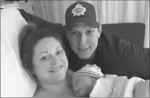  ?? SUSAN HUBLEY, THE CANADIAN PRESS ?? Lindsey Hubley, Mike Sampson and their newborn baby Myles Owen Sampson at the IWK Health Centre in Halifax on March 2.