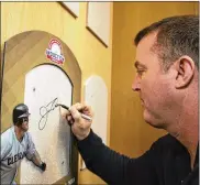  ?? AP ?? Former Indians slugger Jim Thome signs his name in the Plaque Gallery during his orientatio­n tour of the National Baseball Hall of Fame and Museum on Tuesday.