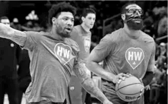  ?? JIM DAVIS/GLOBE STAFF ?? The Celtics, including Marcus Smart (left) and Jaylen Brown, wore T-shirts honoring Heather Walker, the team’s PR director who died Wednesday at 52.