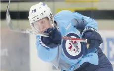  ?? BRIAN DONOGH ?? The Jets’ Patrik Laine fires a shot during his first NHL practice on Monday in Winnipeg. The rookie says his goal is to make the team.