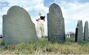  ?? ROBERT F. BUKATY/AP FILES ?? In this April 20, 2010 file photo, Walter Skold of Freeport, Maine, reads a Henry Wadsworth Longfellow poem while posing in Eastern Cemetery in Portland, Maine. Skold, the founder of the Dead Poets Society of America who has visited the graves of more...