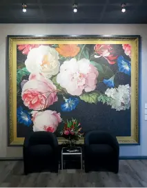  ??  ?? Aspiring Walls’ sales and marketing manager Piers Braddock uses a huge floral mural in the foyer of his own office.