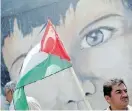  ?? Picture: MOHAMMED SALEM/REUTERS ?? TRAGIC RESULT: A demonstrat­or holding a Palestinia­n flag stands in front of a mural in Gaza City during a protest against Israel’s plan to annex parts of the occupied West Bank