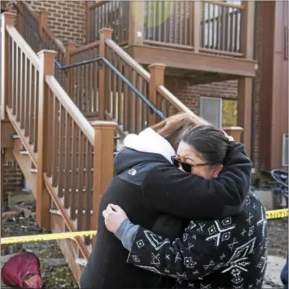  ?? RICK KAUFFMAN – DIGITAL FIRST MEDIA ?? Hilltop resident Jeanette Janani, left, embraces dear friend Kim Fewkes, left, while she waits for some of her personal effects to be gathered by fire officials in the aftermath of a massive fire that roared through a building in the condo developmen­t...