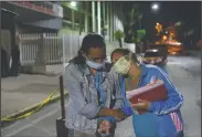  ??  ?? Reacting to labor contractio­ns Mendoza leans on her mother as they leave the Hugo Chavez Frias Public Maternal and Children’s Hospital after doctors ordered them to return home to wait for more frequent contractio­ns, in the El Valle neighborho­od of Caracas, Venezuela, just after midnight on Sept. 10. Mendoza returned to the hospital four hours later, and gave birth to her daughter Peyton, after five hours of labor.