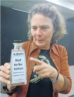  ?? Photo: FAIRFAX NZ ?? Sand and deliver: Vera van der Voorden clutches a bottle of black sand marked ‘‘not to be taken’’ at the Environmen­t Protection Authority hearing in Hamilton.