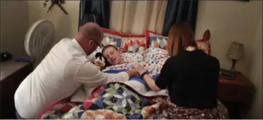  ?? DAVID GOLDMAN — THE ASSOCIATED PRESS ?? Richie Clendenen, lead pastor at Christian Fellowship Church, left, and his wife Jenny, say evening prayers with their son, Trey, 11, as he goes to bed at their home in Benton, Ky., Sunday April 10, 2016. “I worry about the country he’s going to...