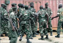  ?? PICTURE: AP ?? DISARRAY: Soldiers from two different units argue after a special unit dispersed a group of protesters by firing into the air in the Musaga neighbourh­ood in Burundi, yesterday. The army has deployed throughout the town to quell protests.