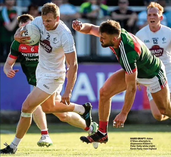  ??  ?? HARD GRAFT: Aidan O’Shea attempts to dispossess Kildare’s Peter Kelly while (right) Kevin Feely rises highest